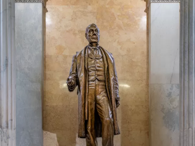 Bronze statue of a person standing.