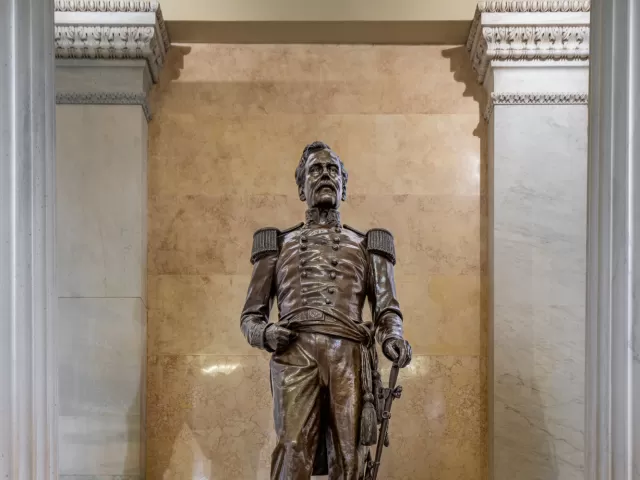 Bronze statue of a person standing.