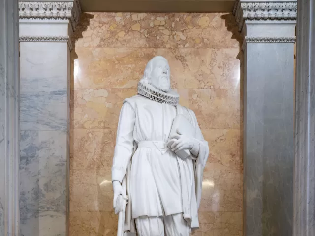 Marble statue of a person standing.