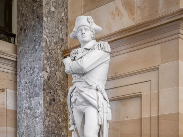 Marble statue of a person standing.