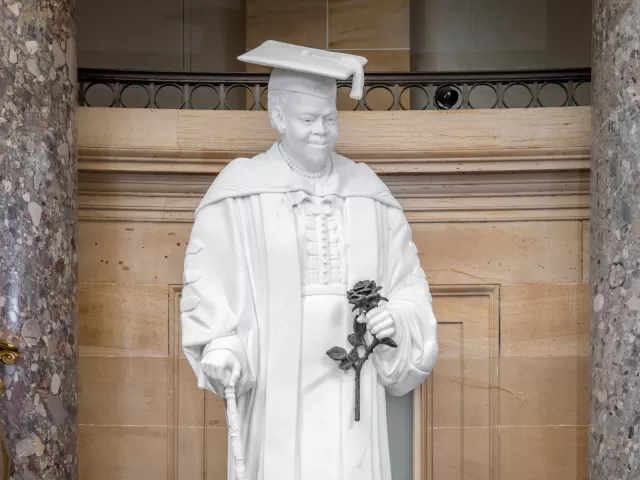 Marble statue of a person standing.