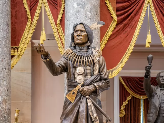 Bronze statue of a person standing.