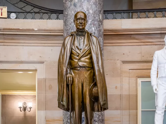 Bronze statue of a person standing.