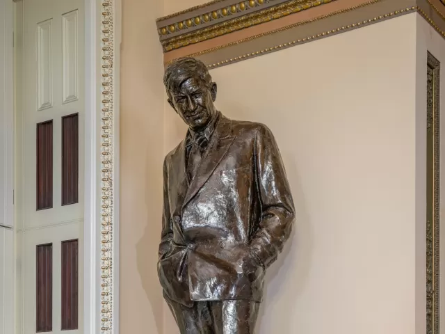 Bronze statue of a person standing.