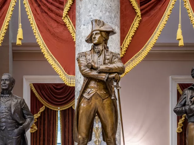 Bronze statue of a person standing.