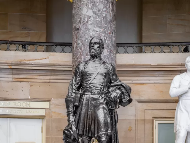 Bronze statue of a person standing.