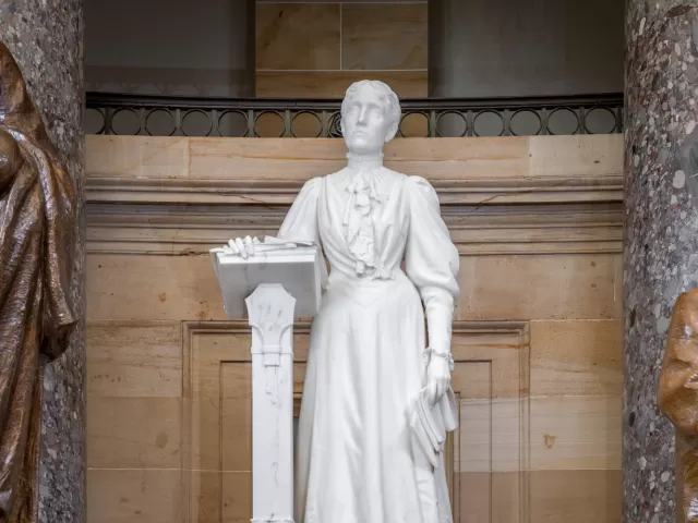 Marble statue of a person standing.