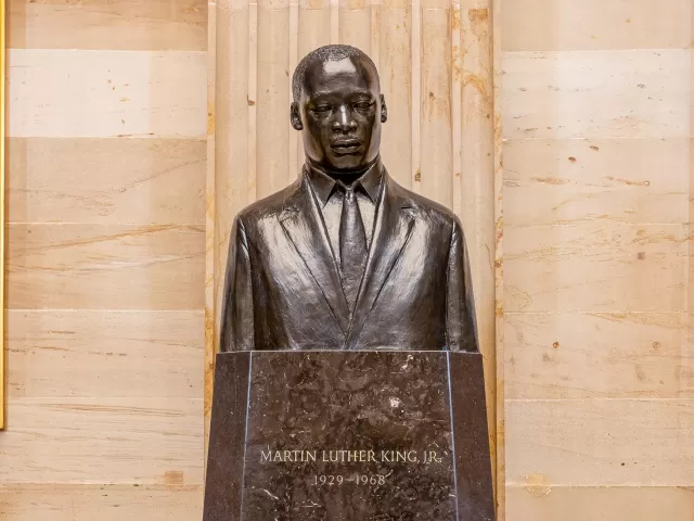 Bronze bust on a pedestal.