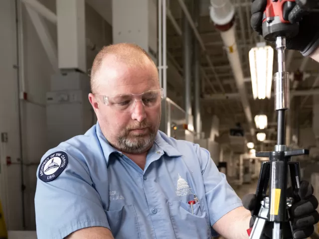 Person standing using equipment.