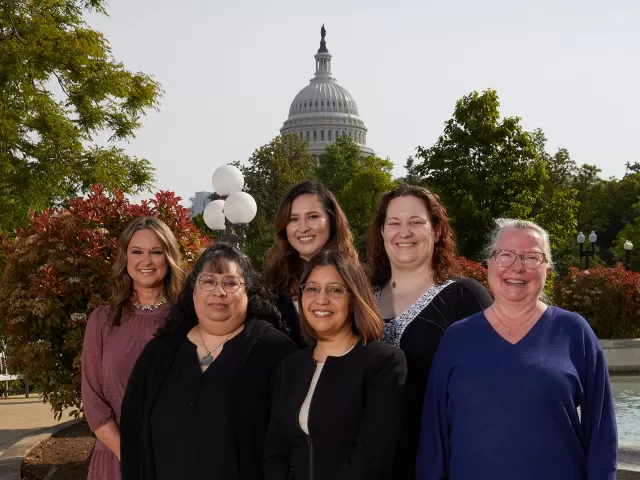 Group of people with the Capitol Dome in the background.
