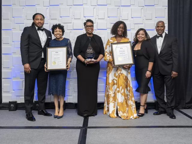 Group of people holding awards.