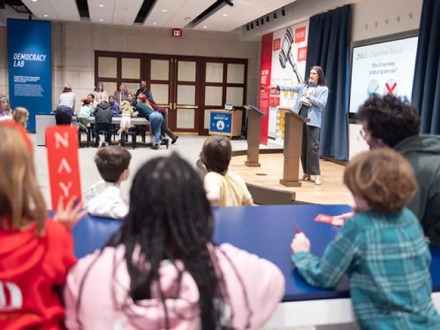 Group of kids listening to a presenter.