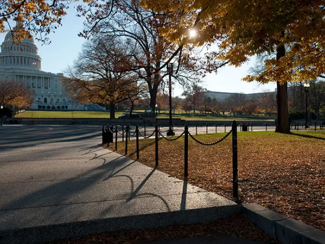 View of the U.S. Capitol from a pathway on the West Front during autumn.