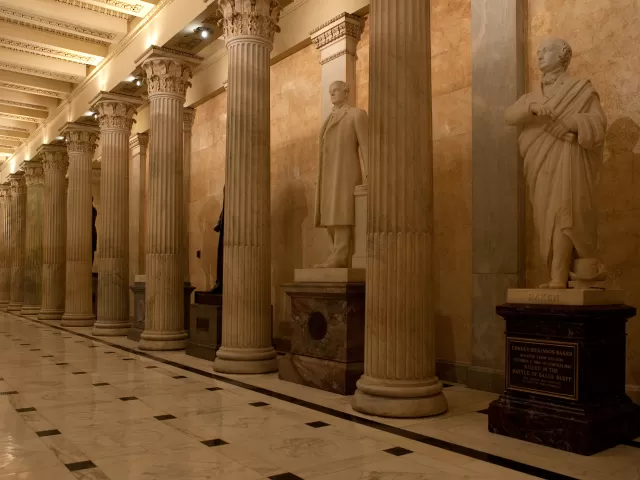 Columns in a room with statues.