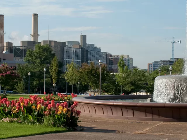 Smokestacks, flowers, fountain.