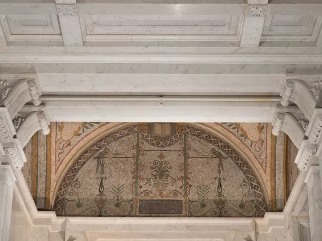 View of column capitals inside a room.