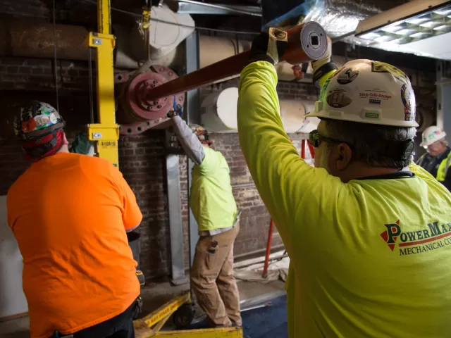 People working on pipes.