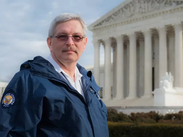 AOC's Joel Evans standing with the Supreme Court Building in the background.