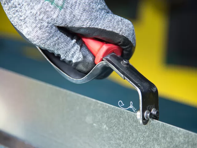 The deburring tool used to remove sharp edges from sheet metal.