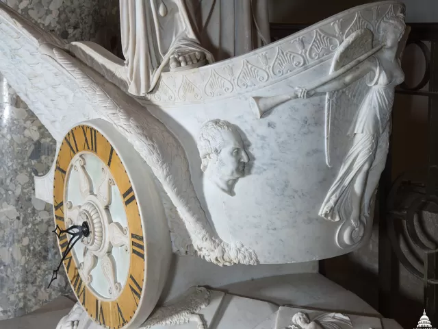 A small bust of George Washington carved into the Car of History marble chariot.