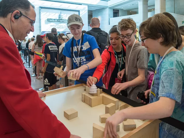 A visitor guide interacts with guests in the U.S. Capitol Visitor Center's Emancipation Hall.