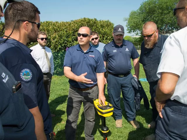 AOC employees test an underground utility locator on the West Front lawn of the U.S. Capitol.