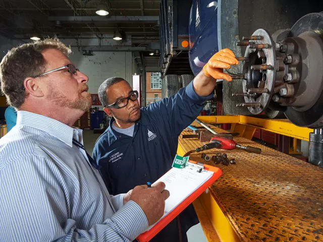 Members of Capitol Grounds and Arboretum inspect a vehicle operating on the U.S. Capitol campus.