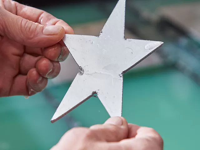 A five-pointed star was cut within seconds by the Architect of the Capitol Sheet Metal Shop.