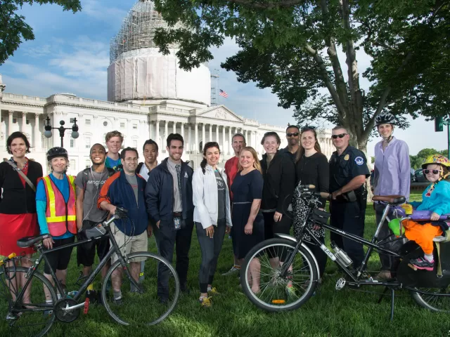 Group of people standing in front of the U.S. Capitol.