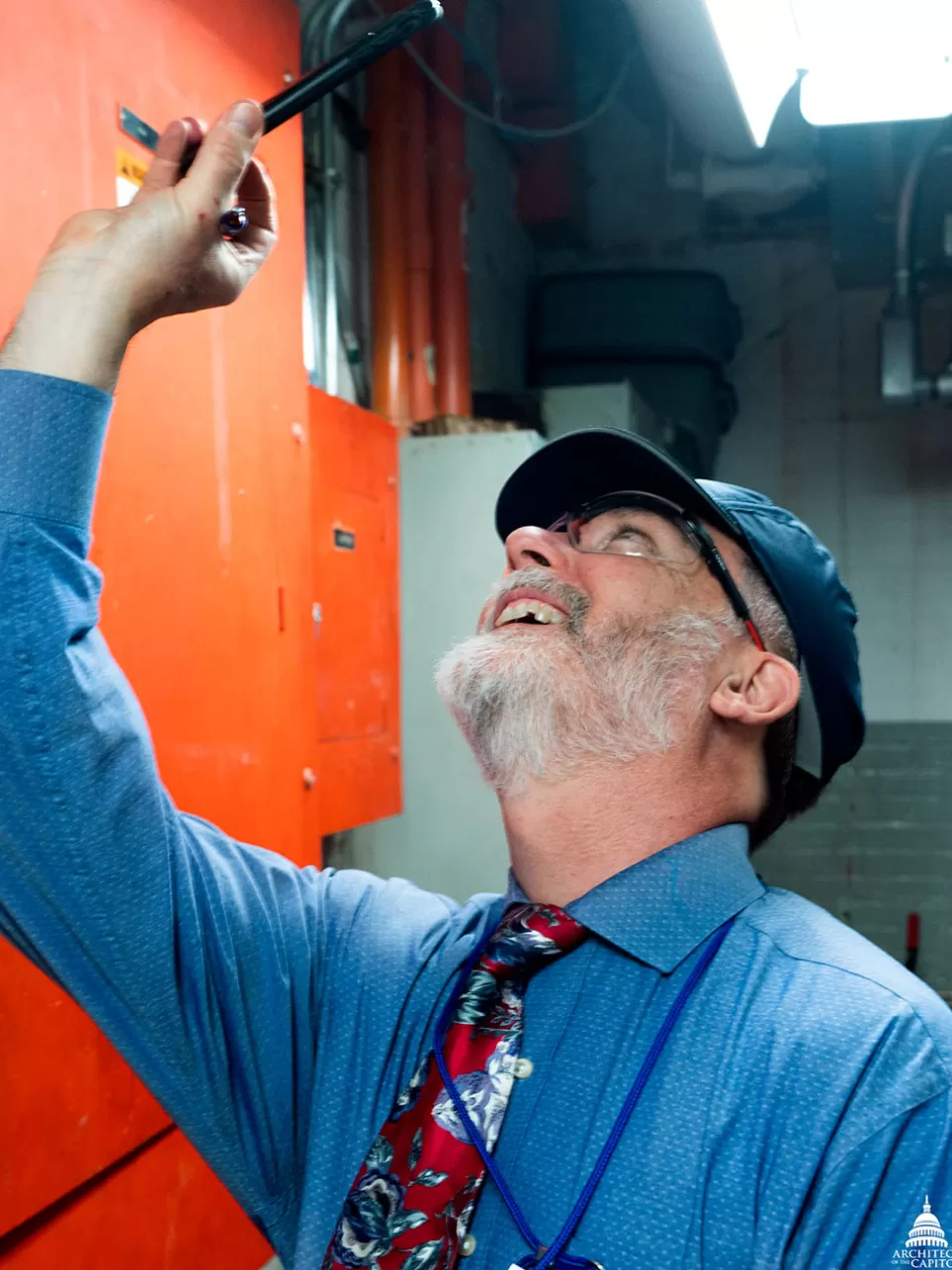 An AOC employee inspects the ceiling of a mechanical space in the U.S. Capitol.