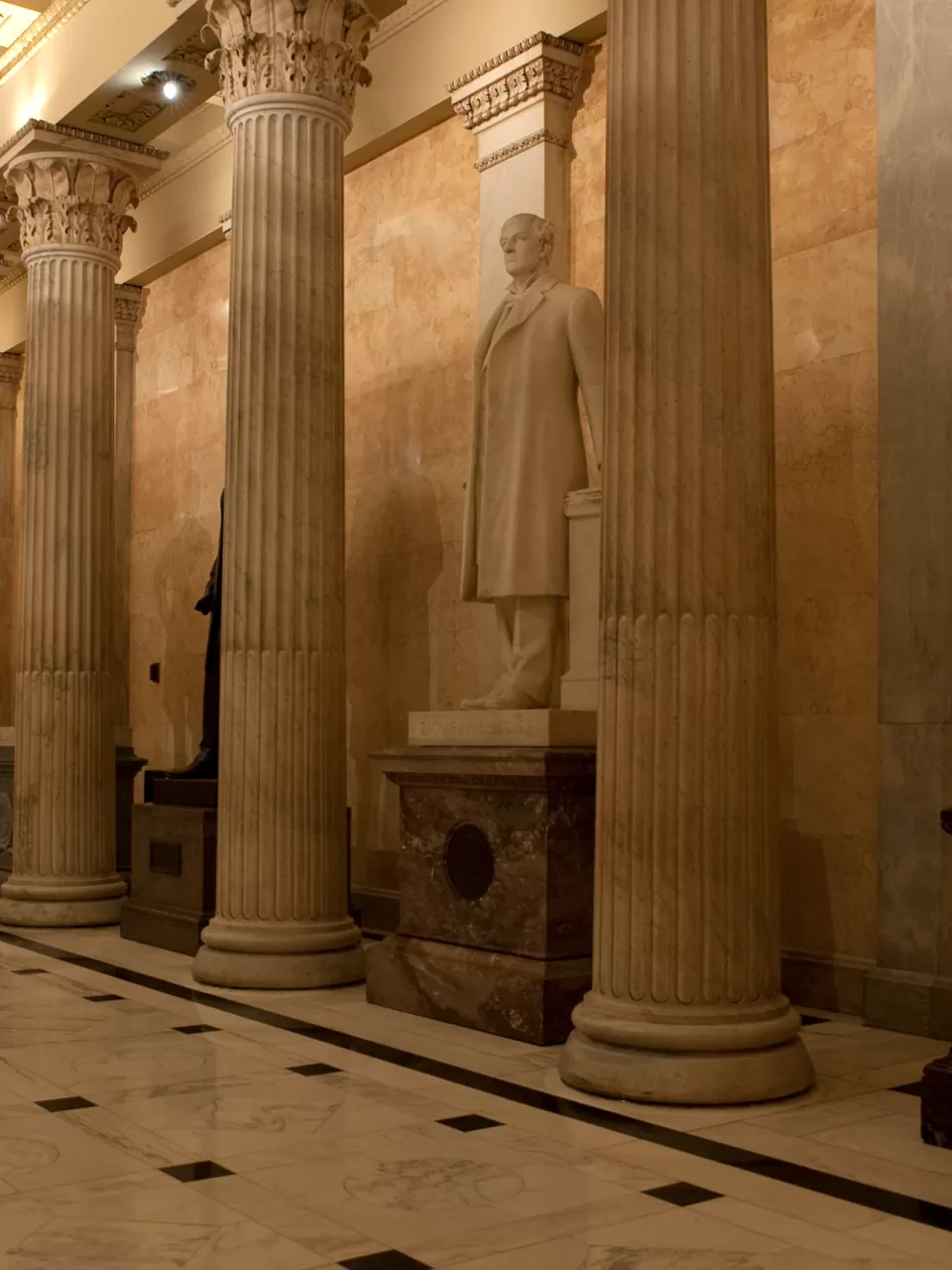 Columns in a room with statues.