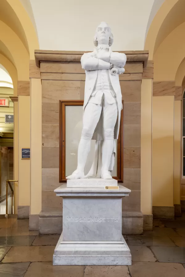 Marble statue of a person standing.