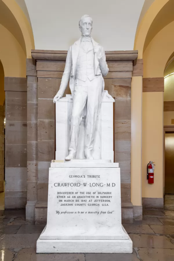 Marble statue of a person standing.