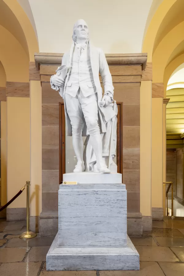 Marble statue of a person standing.