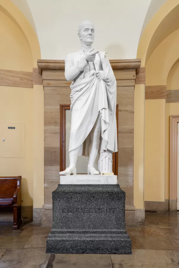 Marble statue of a person standing.