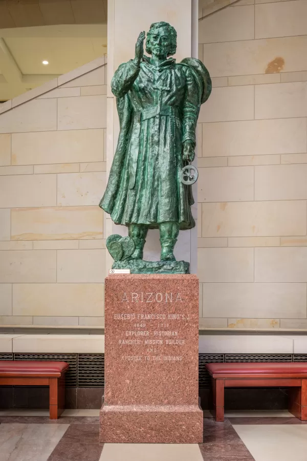 Bronze statue of a person standing.