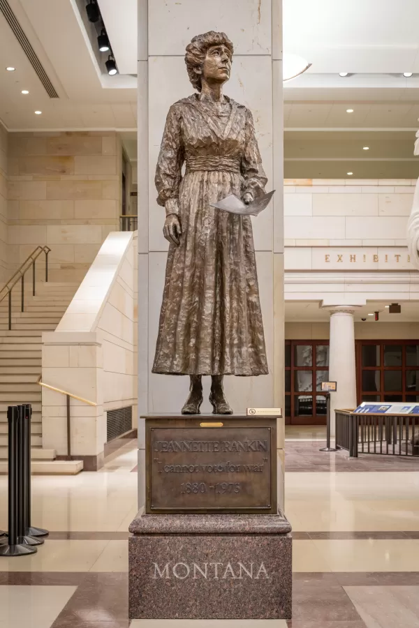 Bronze statue of a person standing.