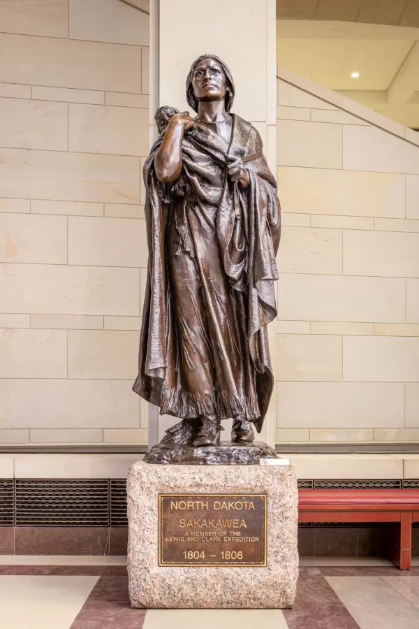 Bronze statue of a person standing.