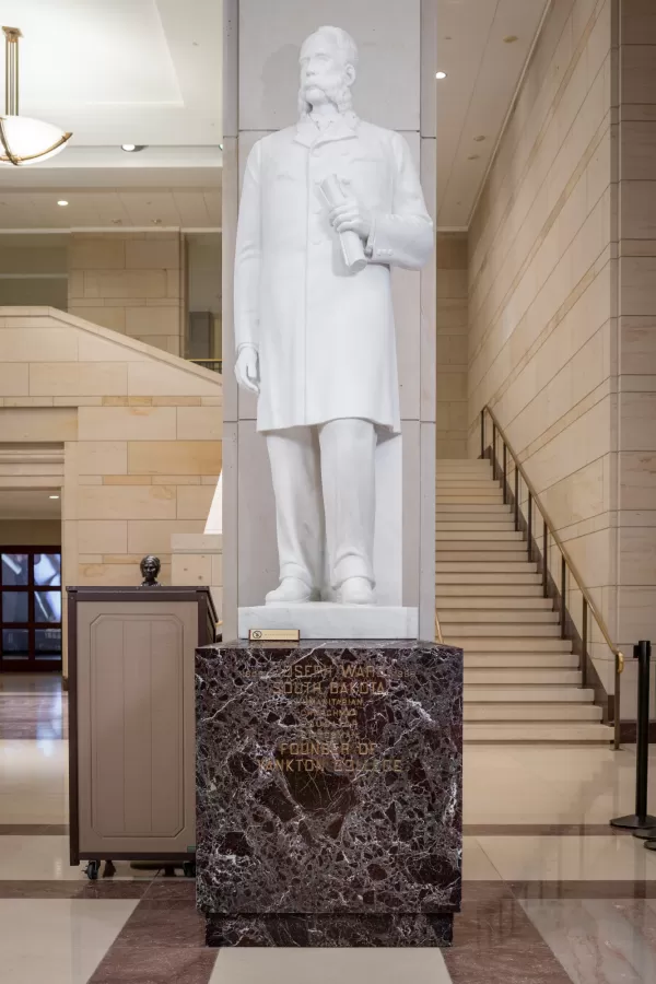 Marble statue of a person standing.