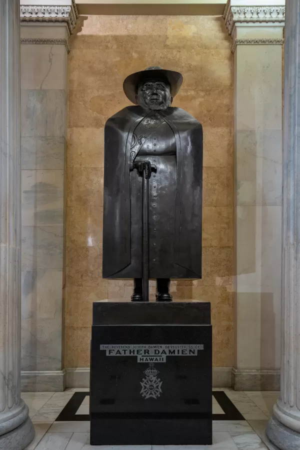 Bronze statue of a person standing.