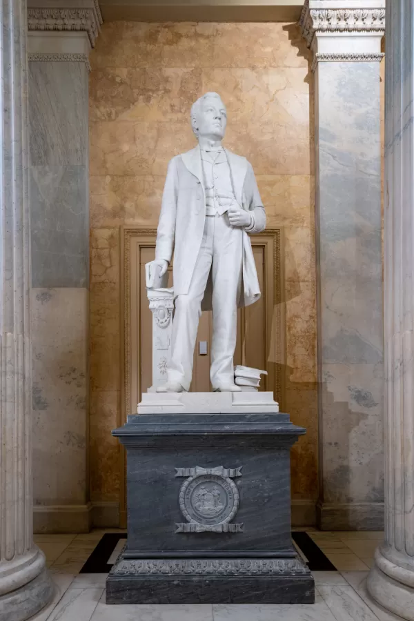 Marble statue of a person standing.