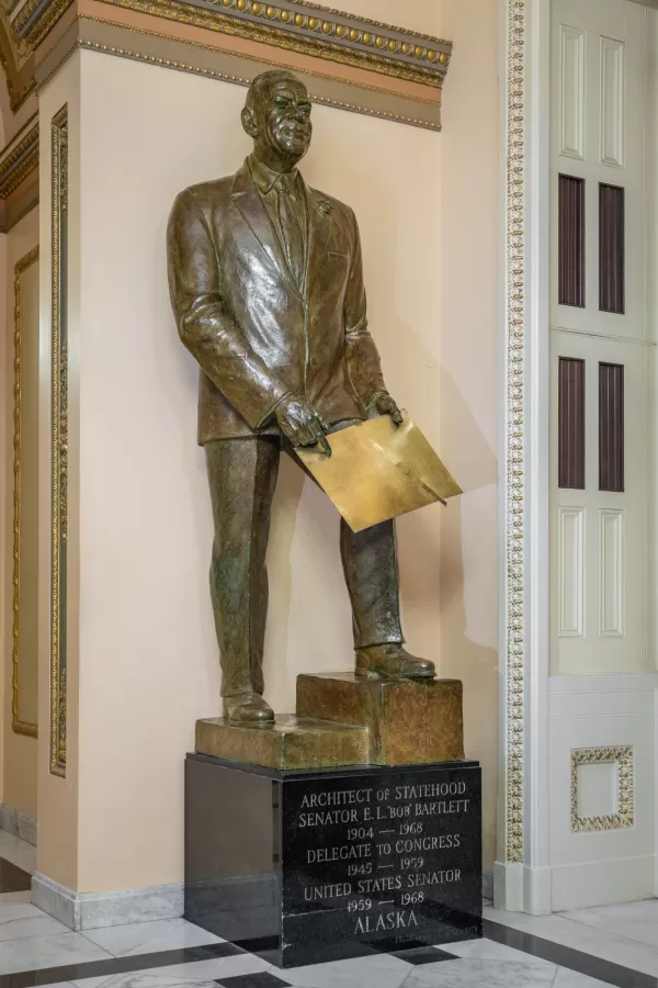 Bronze statue of a person standing.