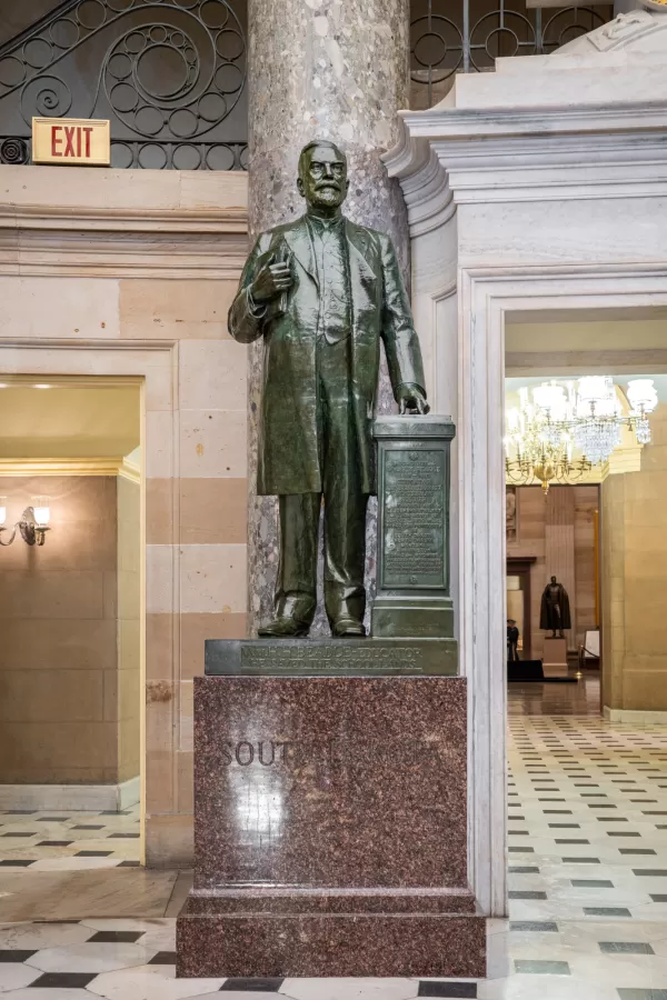 Bronze statue of a person standing.