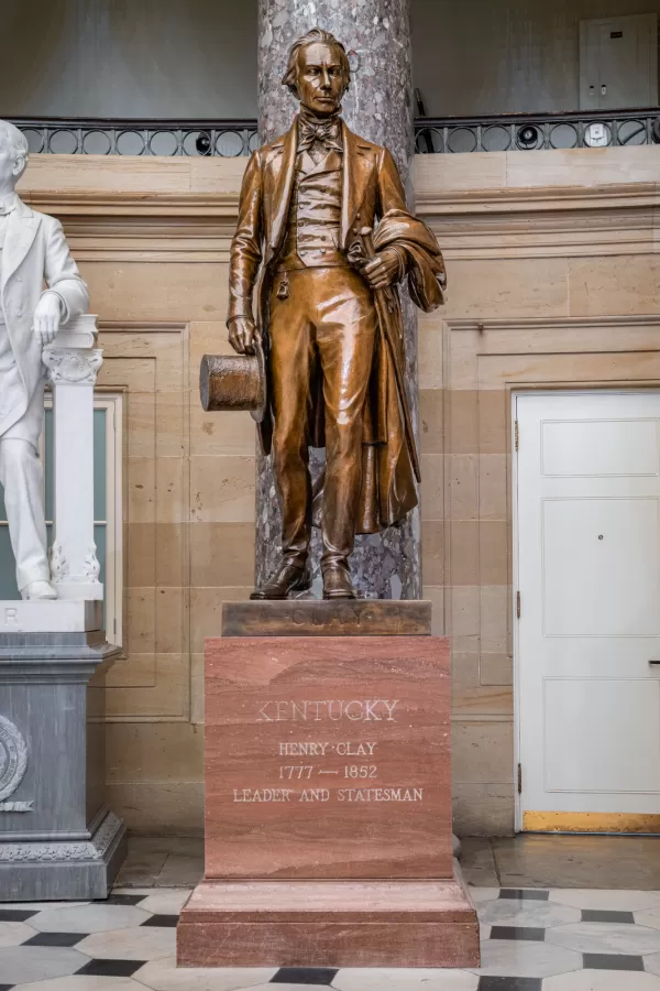 Bronze statue of a person standing.