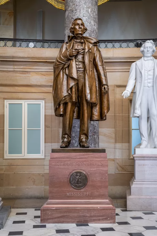 Bronze statue of a person standing.