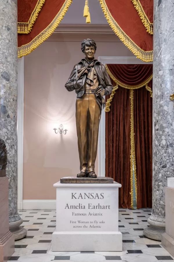 Bronze statue of a person standing.