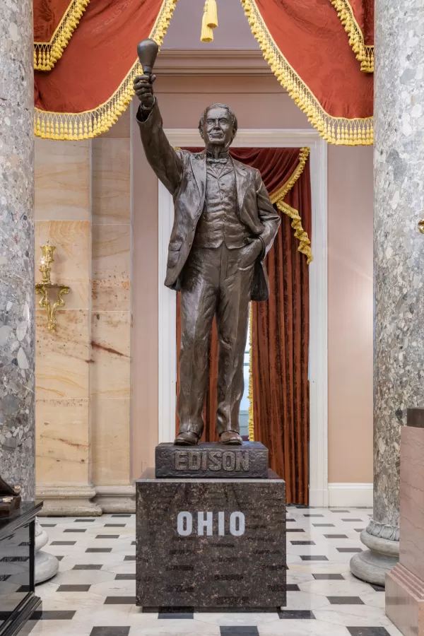 Bronze statue of a person standing.