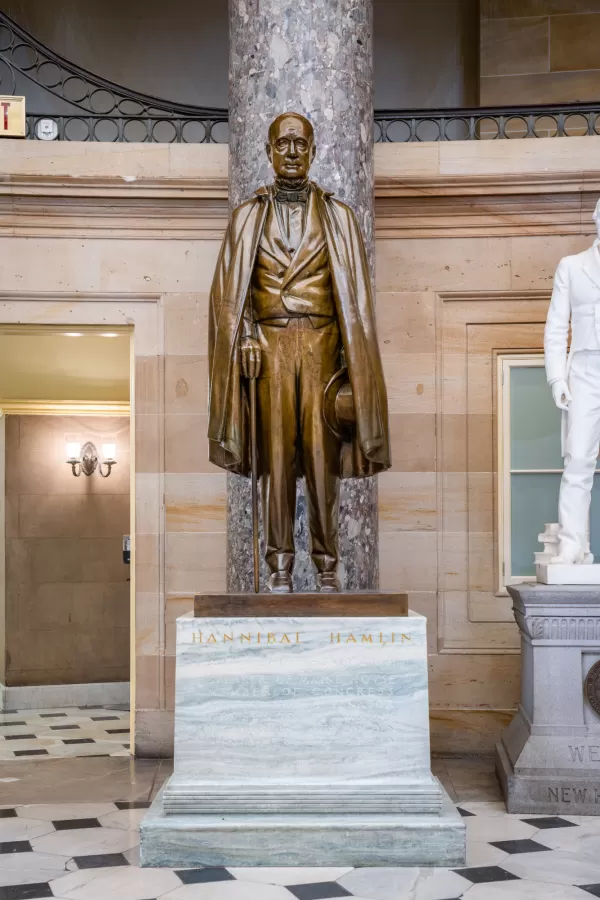 Bronze statue of a person standing.