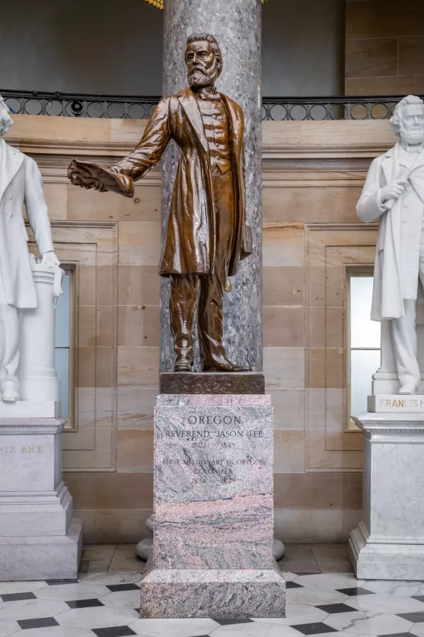 Bronze statue of a person standing.