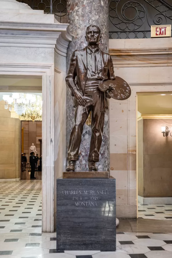 Bronze statue of a person standing.